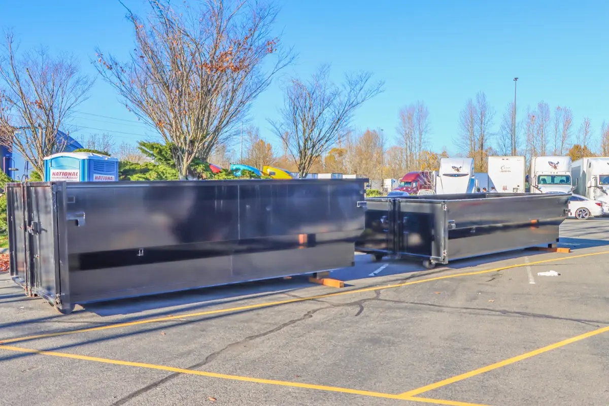 Professional dumpster rental service with roll-off container on residential driveway in Winona Lake